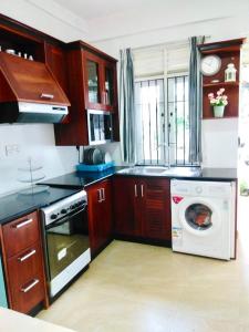 a kitchen with a washing machine and a dishwasher at Millennium Elite in Opata