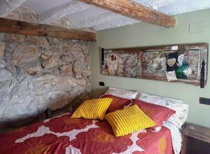 a bedroom with a bed with two pillows on it at Ca la Maria in Lilla