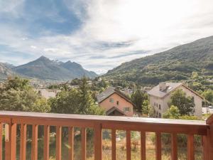 a balcony with a view of a town and mountains at Appartement Briançon, 3 pièces, 4 personnes - FR-1-330C-10 in Briançon