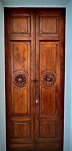 a wooden door with twoartments in a room at Ruanera in Catania