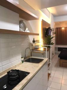 a kitchen with a sink and a counter top at Apartemen Comfy Urbano Bekasi in Bulanbulan