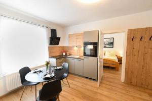 a small kitchen with a table and chairs in a room at Ferienapartments 31erHaus in Hieflau