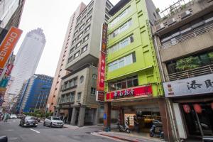 a busy city street with tall buildings and cars at Morwing Hotel Fairytale in Taipei