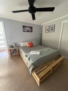 a bedroom with a bed with a ceiling fan at Kima Quarters in Swan Hill
