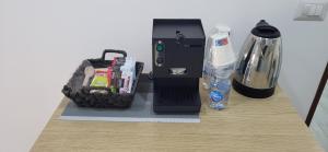 a food processor on a table with a bottle of water at B&B Nonno Walter in Torre del Greco +11 photos