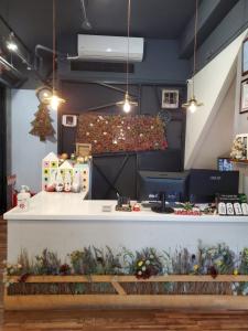 a counter in a flower shop with plants at Slow Wow Hot Spring Hotel in Jiaoxi