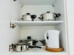 a kitchen with pots and pans on shelves at New - Free Parking - Balcony in Vienna