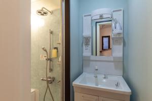 a bathroom with a sink and a shower with a mirror at City center Shibuya -都心縁渋谷- in Tokyo
