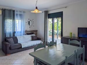 a living room with a couch and a table at Spacious Holiday House with Shared Pool in Hanioti