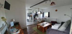 a living room with a couch and a table at Fewo Steuerbord in Rambin
