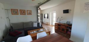 a living room with a couch and a table at Fewo Steuerbord in Rambin