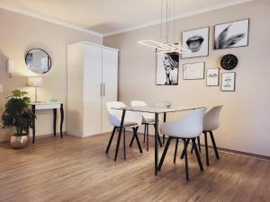 a dining room with a table and chairs at Appartementanlage Ostseeblick in Kühlungsborn