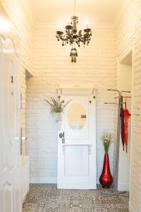 a chandelier hangs above a white door in a room at Kobieciarnia in Tczew