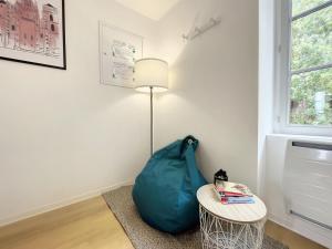 a room with a bean bag chair and a lamp at L'Oustal Amans Rodat in Rodez