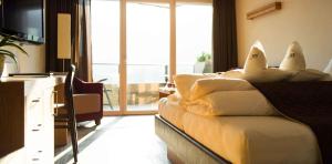 una camera d'albergo con letto e cuscini sopra di Hotel Resmairhof a Scena