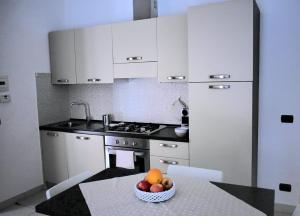 a kitchen with a bowl of fruit on a table at bilocale Rachele in Sestri Levante