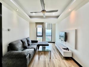 a living room with a couch and a tv at Casa Residency in Kuala Lumpur