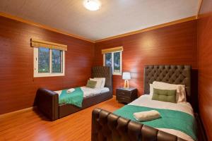 a bedroom with two beds and a couch in it at The Murray River Weekender in Ulupna West +54 photos