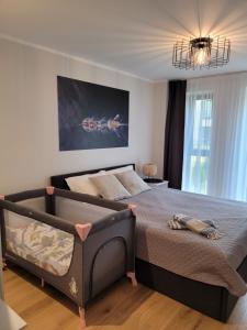 A bed or beds in a room at Divas Laivas apartments with a terrace