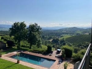 a swimming pool in a yard with a view of a valley at Apartment mit Pool und Aussicht in Kitzeck im Sausal