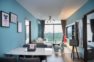 a living room with a table and a couch at BEARBRICK homestay near beach, CSJ Tower Apartment Vung Tau in Vung Tau