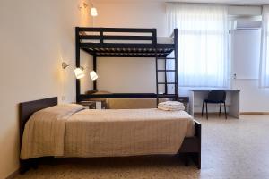 a bedroom with a bunk bed with a desk at Soleē, Family Holidays & Hostelling in Cesenatico +95 photos