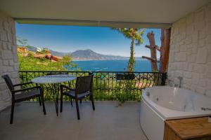 einen Balkon mit einer Badewanne, einem Tisch und Stühlen in der Unterkunft Castle Boutique Hotel Alanya in Alanya