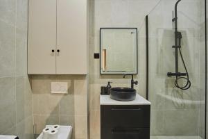 a bathroom with a sink and a shower at Apartment Notre Dame de Paris by Studio prestige in Paris