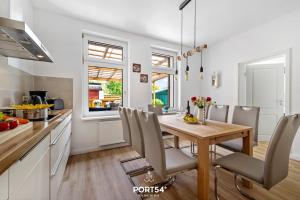 a kitchen and dining room with a wooden table at Villa Nova in Büsum