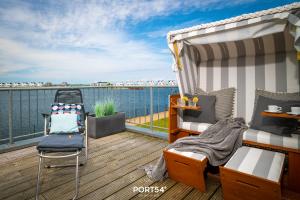 a balcony with beds and a view of the water at Meerhaus 18 in Olpenitz