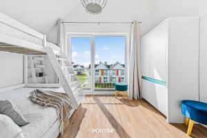 a bedroom with a bunk bed and a window at Meerhaus 18 in Olpenitz