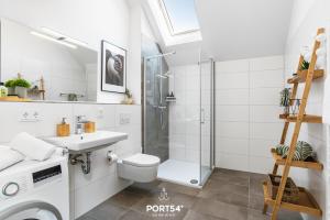 een badkamer met een douche, een toilet en een wastafel bij Fjordsegler in Olpenitz