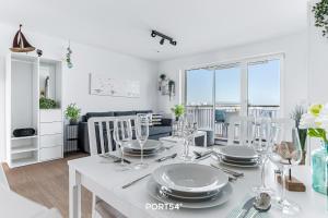 a dining room and living room with a table and chairs at Hafenmelodie in Olpenitz