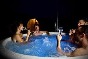 a group of people in a bath tub with wine glasses at Locanda Fungo Reale in Valloriate +12 photos