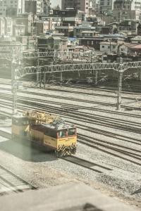 a train on tracks with a city in the background at 31page in Seoul