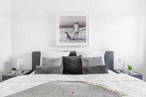 a bedroom with a bed with a picture on the wall at Marina Sunrise in Olpenitz