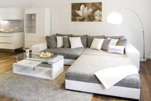 a living room with a couch and a table at Penthouse am Glockenturm in Flensburg +10 photos