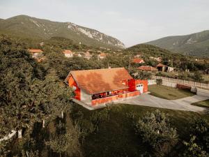 a house with a red roof on a hill at Vikendica Castanea Banja Ždrelo in Petrovac na Mlavi