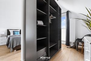 a black bookcase in a bedroom with a bed at Lagunen Lodge in Büsum