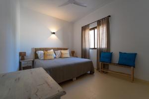 a bedroom with two beds and a window at Arenas del Mar Formentera in Es Arenals