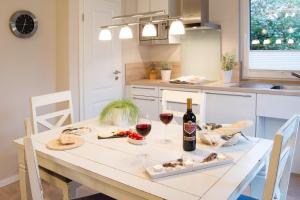 a table with two glasses of wine and food on it at Möwennest Solitüde in Flensburg