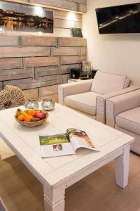 a white coffee table with a bowl of fruit on it at Möwennest Solitüde in Flensburg