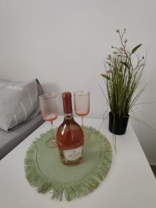 a bottle of wine and two glasses on a table at Apartment with terrace and parking in Eilat