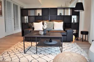 a living room with a couch and a coffee table at Strandhaus Fördeblick in Langballig