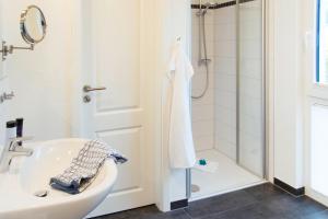 a bathroom with a sink and a shower at Strandquartier Solitüde in Flensburg +14 photos