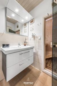 a white bathroom with a sink and a shower at Ferienhaus Ostseelchen Marina Wendtorf in Wendtorf +32 photos