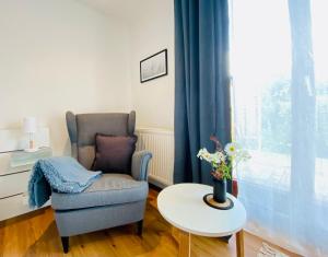 a living room with a chair and a table and a window at Schlunz in Kappeln