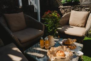 a table with food and drinks on a patio at Swallow Cottage, Bakewell in Bakewell