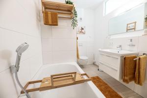 een badkamer met een douche, een bad en een wastafel bij cloud nine in Olpenitz