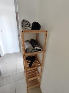 a shelf in a bathroom with towels on it at Apartment with terrace and parking in Eilat
